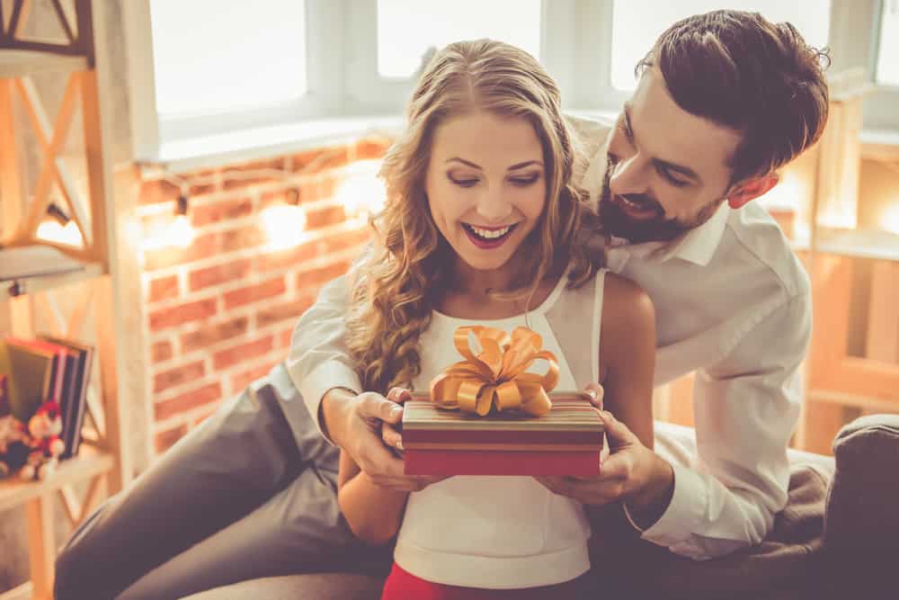 man giving present to woman