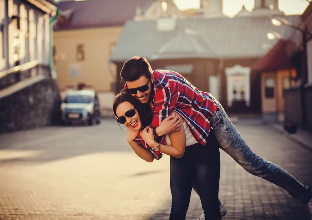 woman carry man on his back