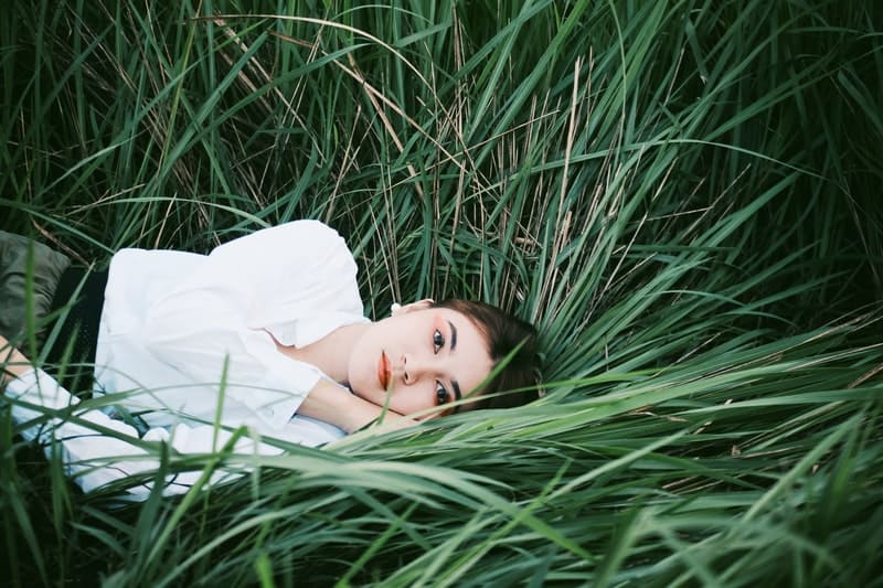 allvarlig kvinna som ligger i gräset