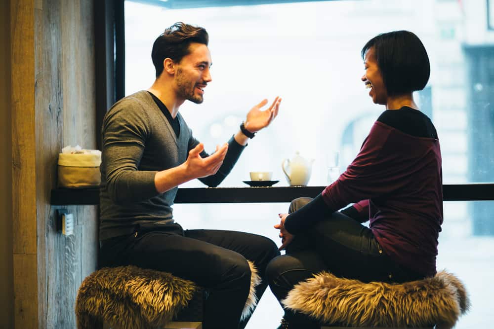 ett le par sitter på ett kafé och pratar