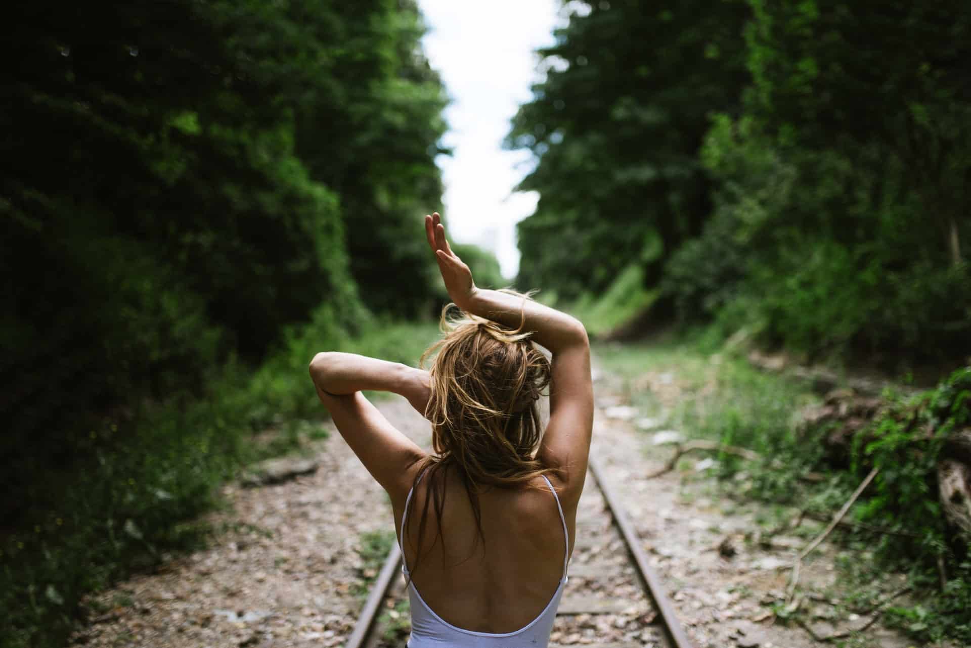 blond kvinna som står på järnvägen