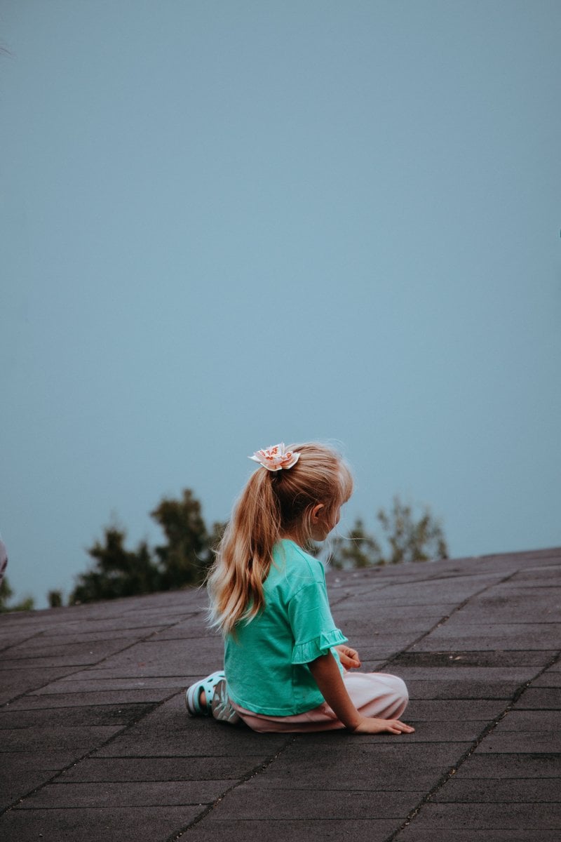 A Girl Sitting Outdoors &middot; Free Stock Photo