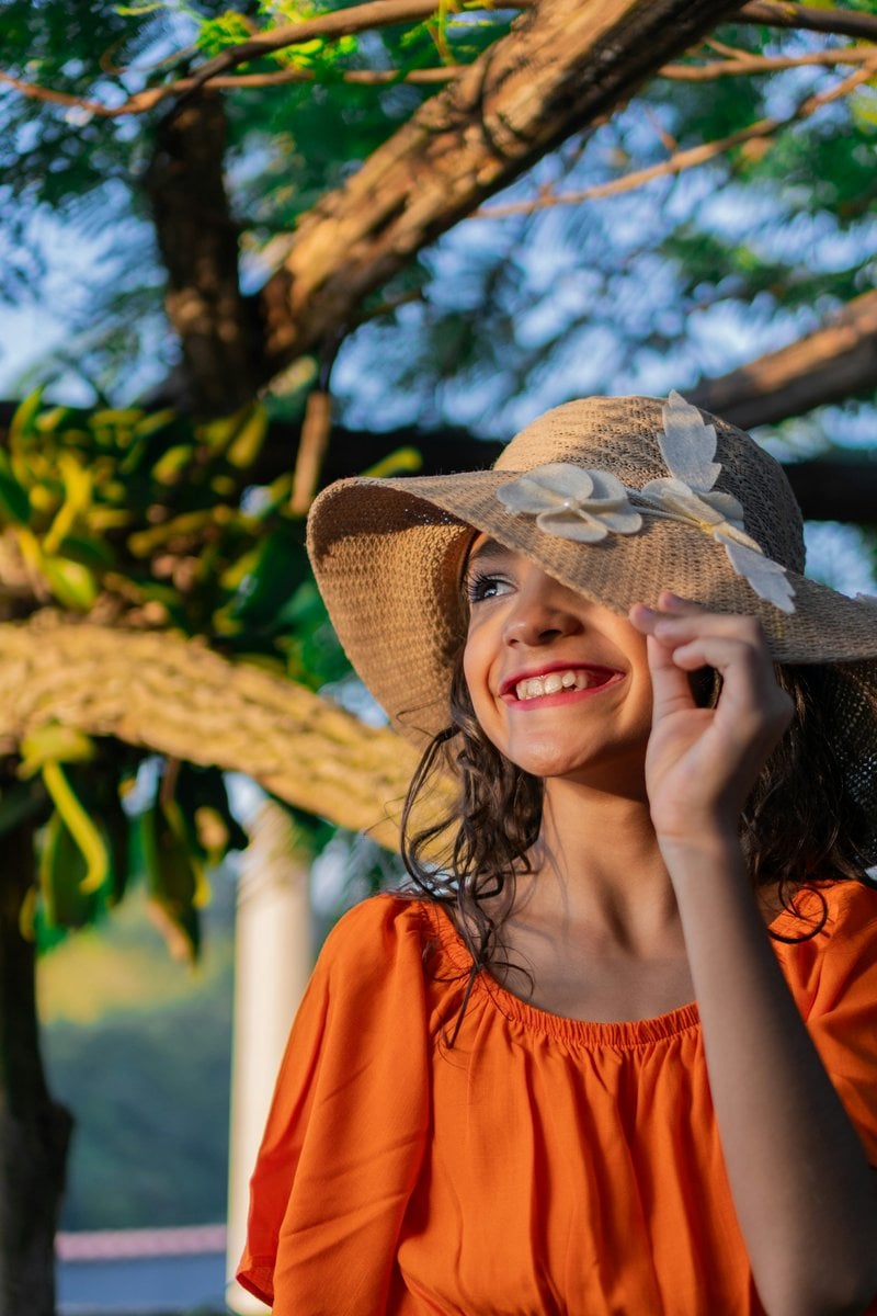 A little girl wearing a hat and smiling - Free Photo on Unsplash