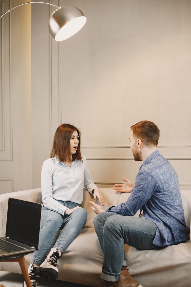 Close-Up Shot of a Man and a Woman Talking while Sitting on a Couch &middot; Free  Stock Photo