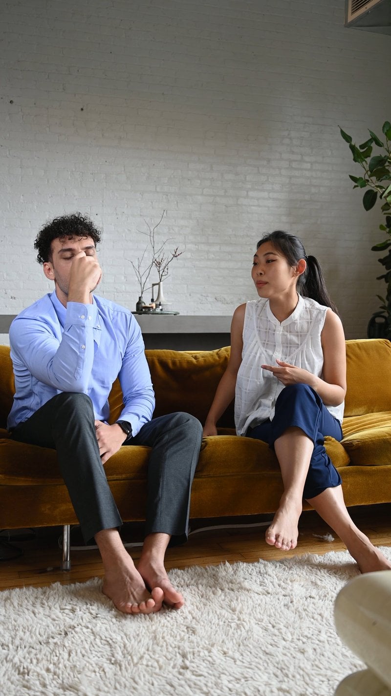 Couple Fighting while Sitting in a Sofa