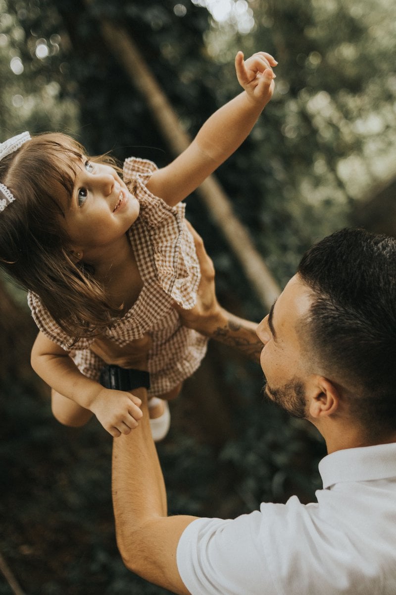 Father Lifting Daughter Outdoors in Playful Moment &middot; Free ...