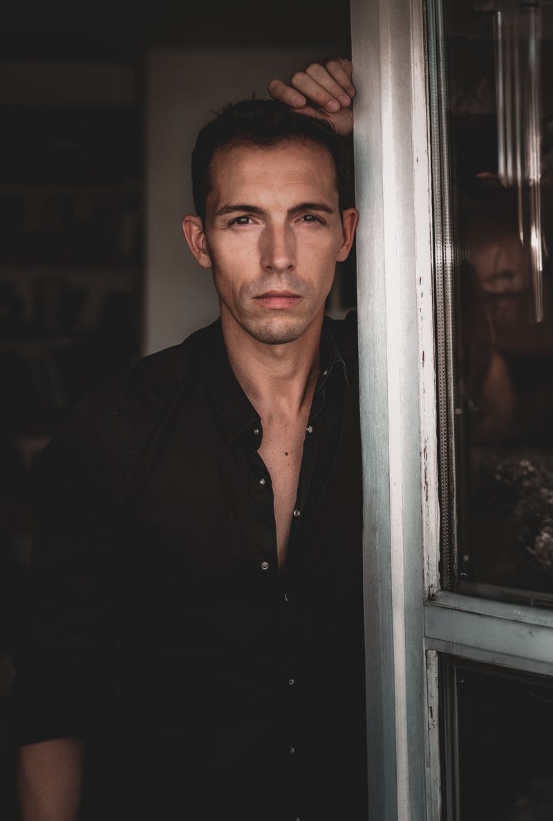 Man with a Serious Facial Expression Standing beside an Opened Window &middot;  Free Stock Photo