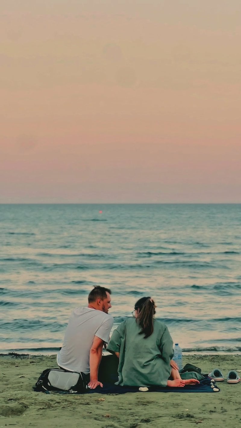 Romantic Couple on Tranquil Beach at Sunset