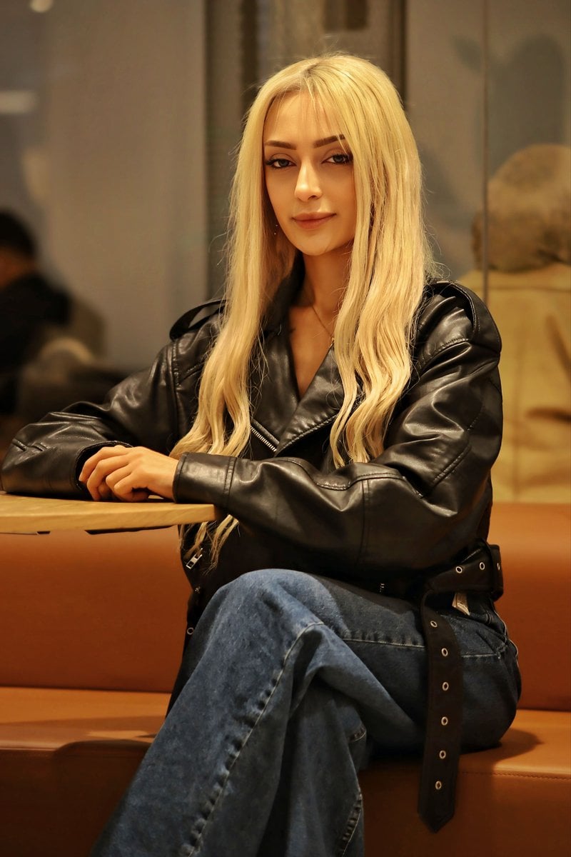 Stylish Woman in Leather Jacket at Cafe &middot; Free Stock Photo