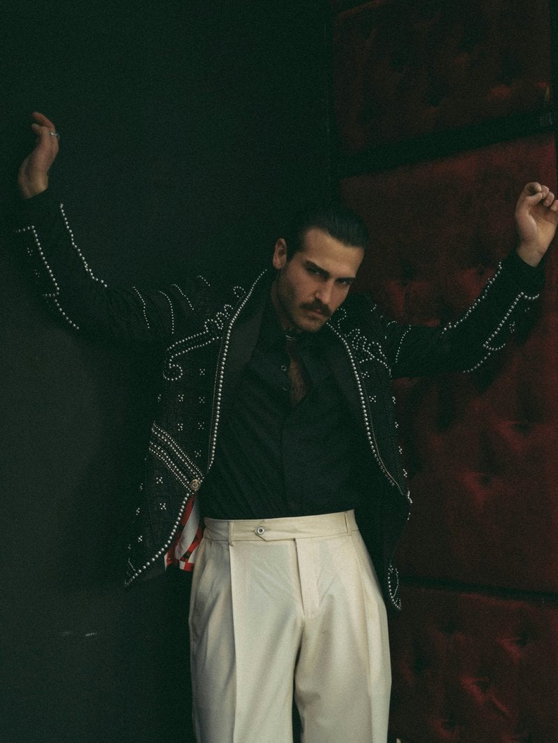 Stylish man poses confidently with an artistic jacket. photo &ndash; Free Blue  Image on Unsplash