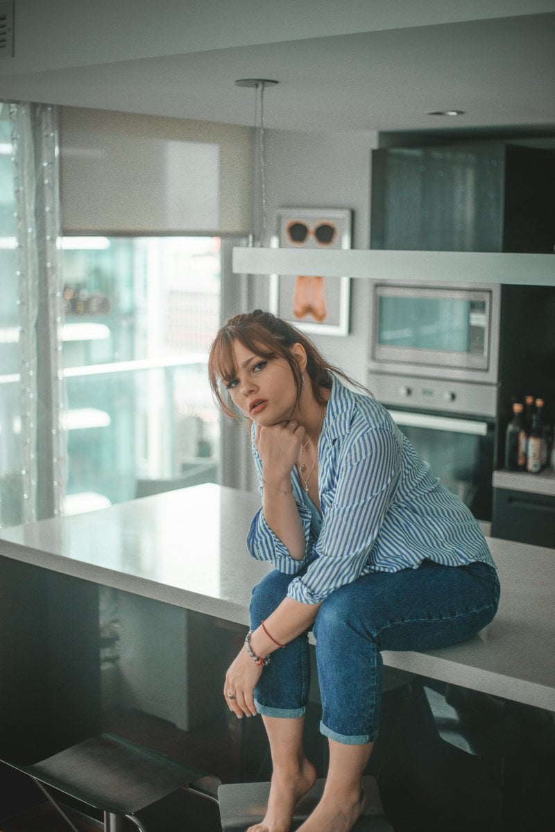 Woman sitting in kitchen photo &ndash; Free Image on Unsplash