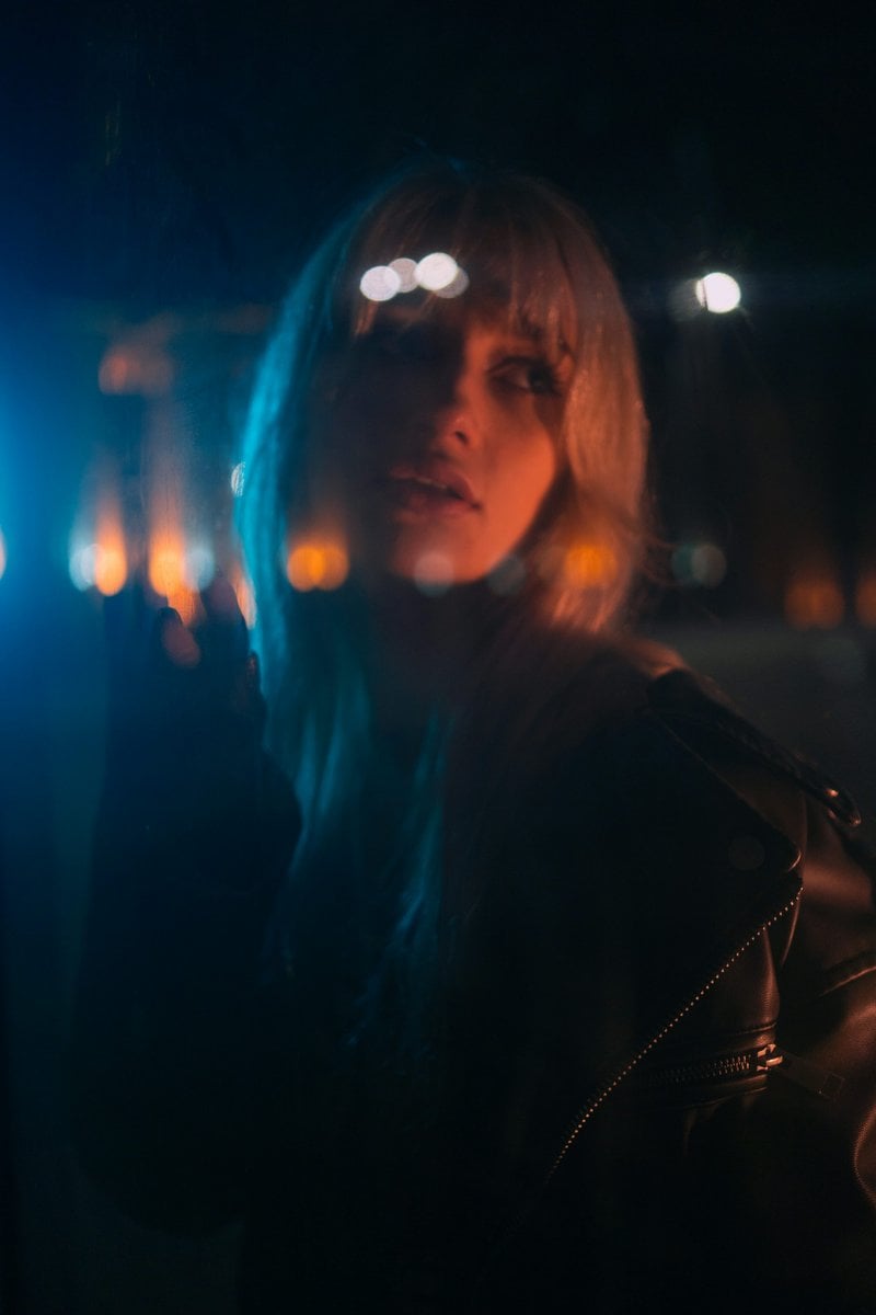 Woman with blonde hair illuminated by blue and orange lights - Free Photo  on Unsplash