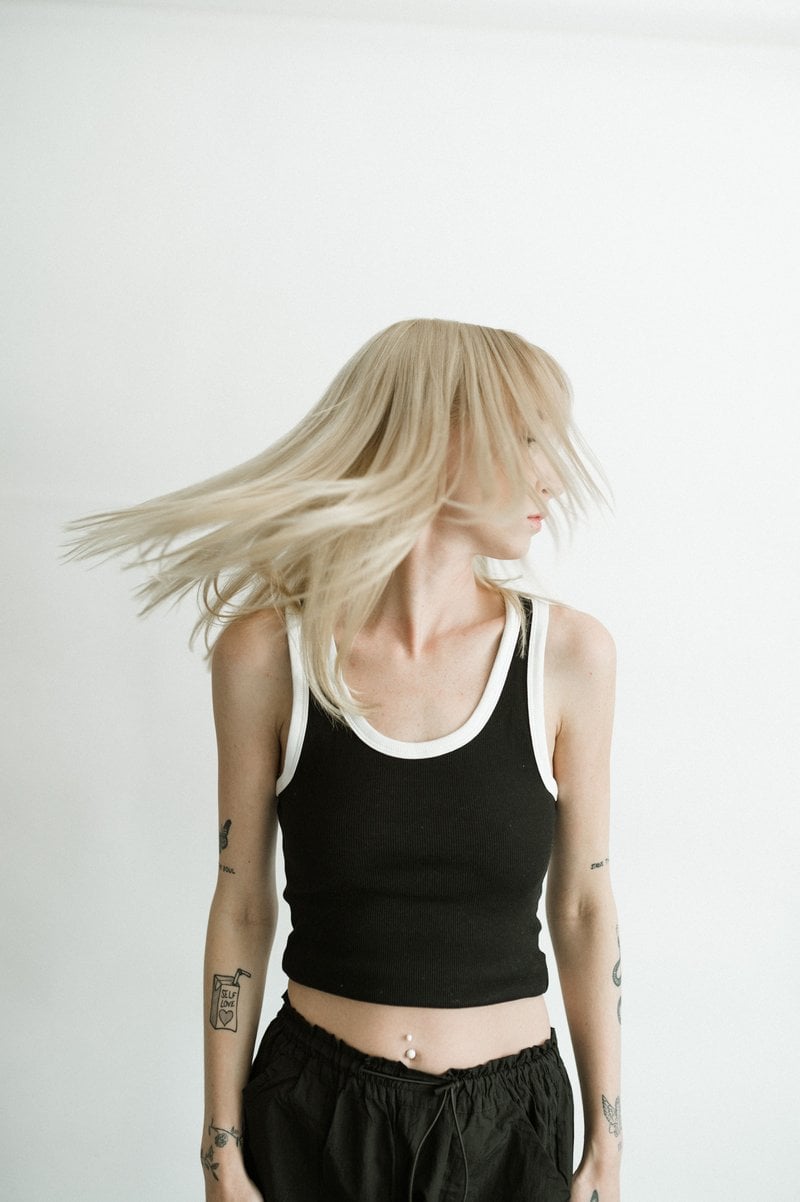 Young Woman with Tattoos Posing in Studio &middot; Free Stock Photo