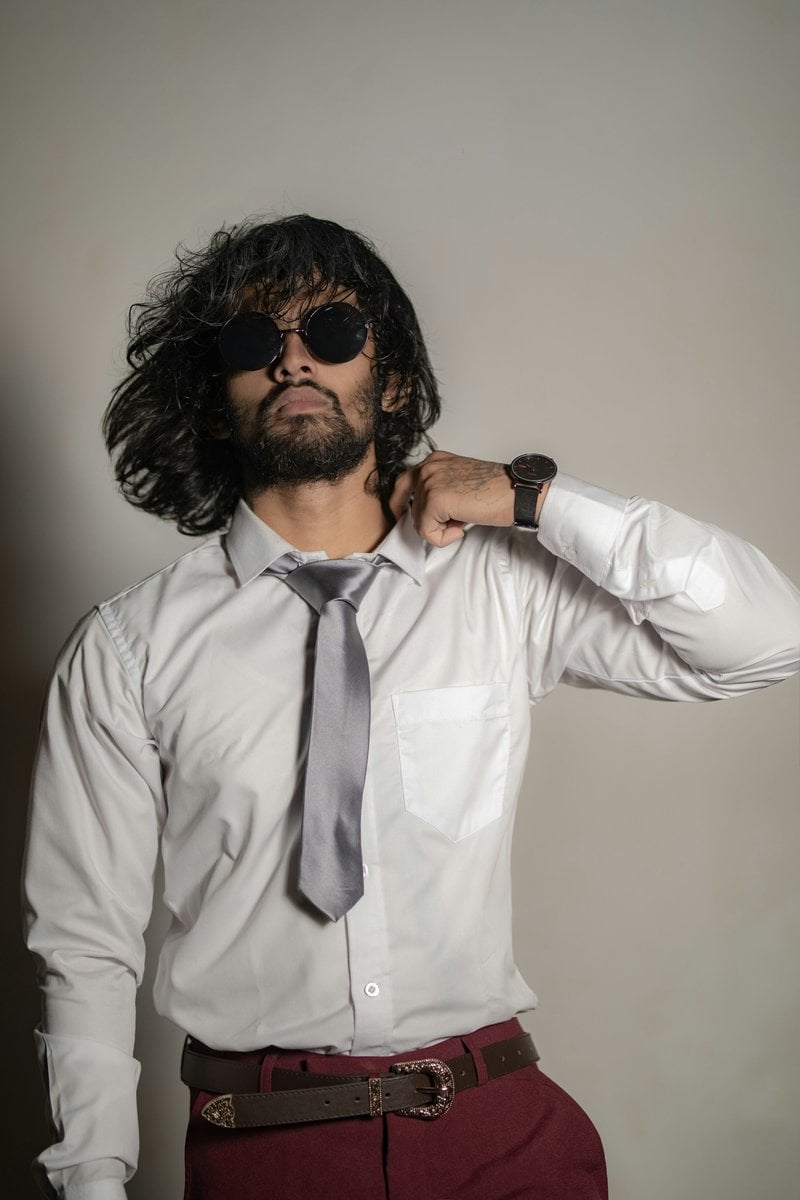 A stylish man in sunglasses, white shirt, and red pants - Free Photo on  Unsplash
