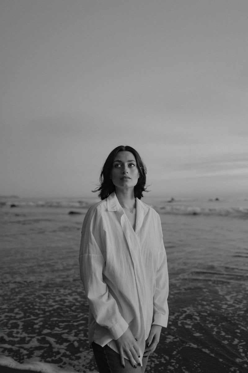 Woman stands alone at the ocean's edge - Free Photo on Unsplash