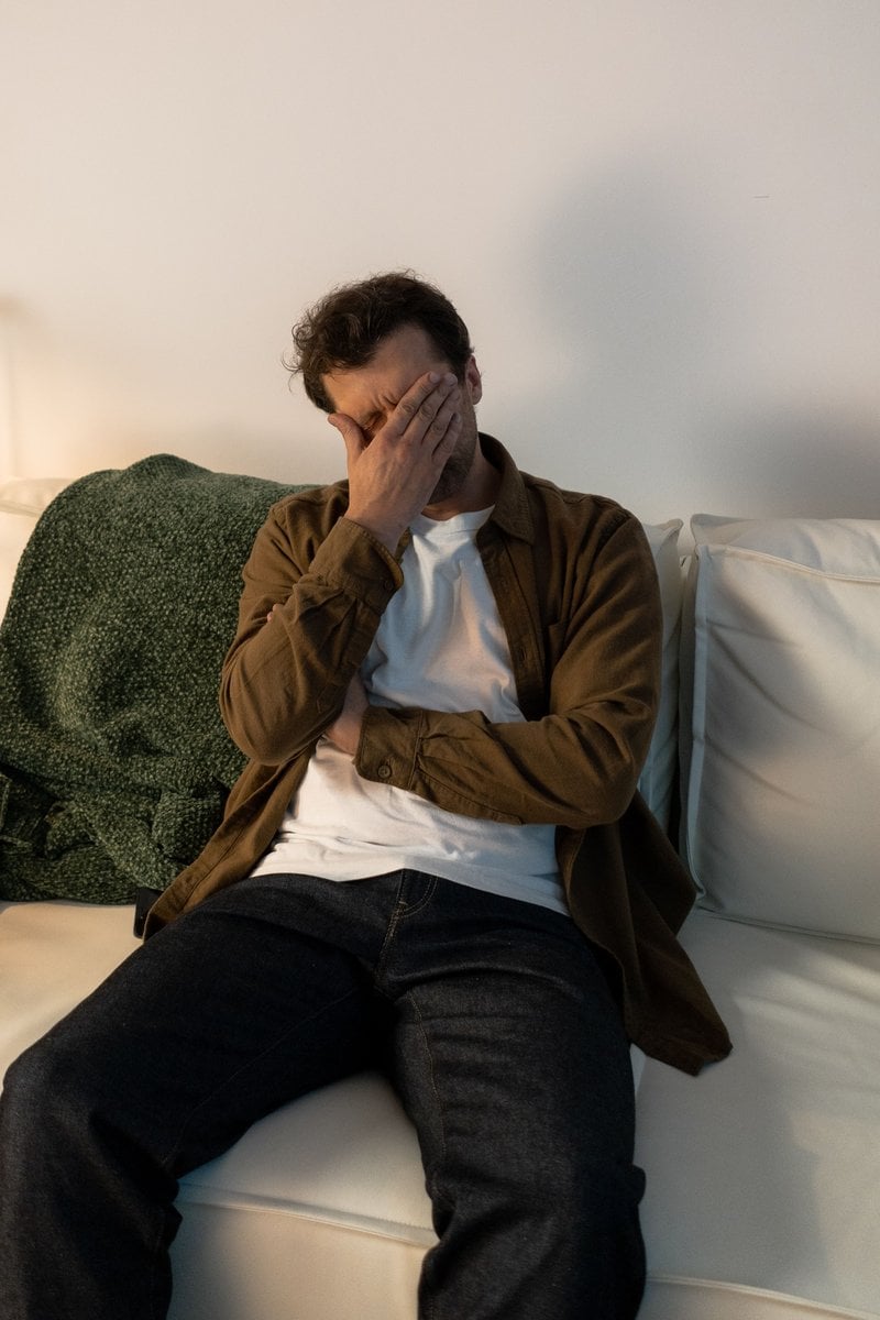 A Distressed Man Sitting on a Couch &middot; Free Stock Photo