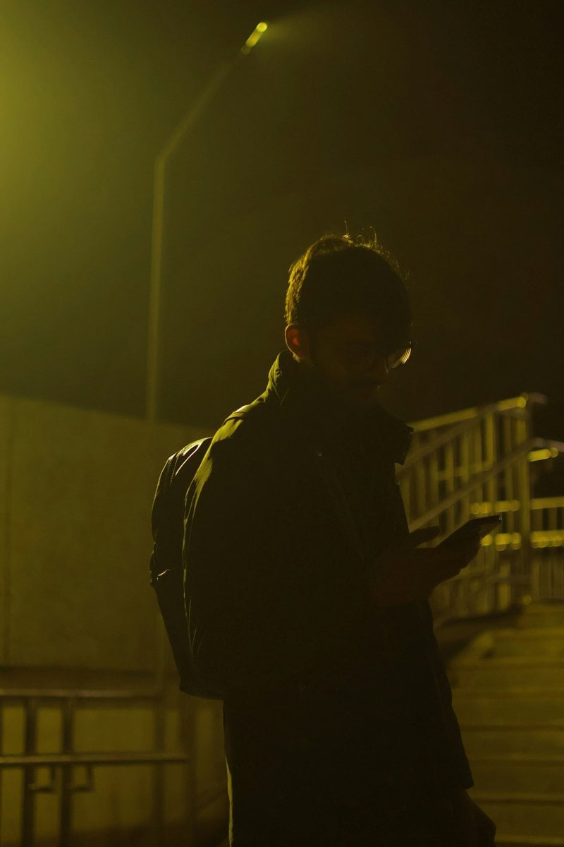 Person looking at phone at night with street light - Free Photo on Unsplash